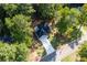 Aerial view of the home displaying the roof, driveway, and lush green trees at 3563 Brenda Ct, Douglasville, GA 30135