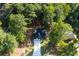 Aerial view of home showing the roof, driveway, and surrounding trees in a wooded area at 3563 Brenda Ct, Douglasville, GA 30135