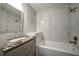 Bathroom featuring modern fixtures, a new vanity, and a shower-tub combo with decorative tile at 3563 Brenda Ct, Douglasville, GA 30135