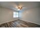 Bedroom featuring hardwood floors, neutral paint, a ceiling fan, and a window for natural light at 3563 Brenda Ct, Douglasville, GA 30135