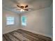 Bedroom featuring hardwood floors, a ceiling fan, and windows providing natural light at 3563 Brenda Ct, Douglasville, GA 30135