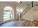 Bright foyer with hardwood floors, staircase and a large window at 3563 Brenda Ct, Douglasville, GA 30135