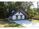 Charming home featuring stone accents, white siding, and a well-manicured lawn surrounded by mature trees at 3563 Brenda Ct, Douglasville, GA 30135