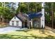 Attractive home with stone and white exterior, an arched entry, and lush landscaping on a well maintained lawn at 3563 Brenda Ct, Douglasville, GA 30135