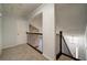 Second-floor hallway with carpeting and updated black iron railing overlooking the home's entry at 3563 Brenda Ct, Douglasville, GA 30135