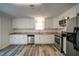 Beautiful kitchen with stainless appliances, white cabinets and modern countertops at 3563 Brenda Ct, Douglasville, GA 30135