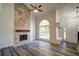 Living room features a stone fireplace, vaulted ceiling and new wood flooring at 3563 Brenda Ct, Douglasville, GA 30135