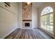 Bright living room with stone fireplace, wood floors, and large window at 3563 Brenda Ct, Douglasville, GA 30135