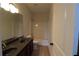 Bright bathroom features double sink vanity and shower over tub at 3877 Lake Sanctuary Way, Atlanta, GA 30349