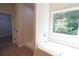 Bathroom includes a large garden tub with a view of the wooded property at 3877 Lake Sanctuary Way, Atlanta, GA 30349