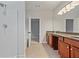 Bathroom featuring double vanity with cabinets and tiled floor at 3877 Lake Sanctuary Way, Atlanta, GA 30349