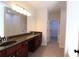 Large bathroom features dual sinks and an entrance to the walk-in closet at 3877 Lake Sanctuary Way, Atlanta, GA 30349