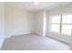 Neutral bedroom with carpeted floor, white walls, and one window at 3877 Lake Sanctuary Way, Atlanta, GA 30349