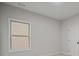 Bright bedroom with a window, neutral walls, and carpeted flooring at 3877 Lake Sanctuary Way, Atlanta, GA 30349