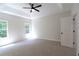 Light-filled bedroom offers a ceiling fan and plush carpet at 3877 Lake Sanctuary Way, Atlanta, GA 30349