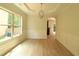 Bright dining room with light wood floors, chandelier and wainscoting at 3877 Lake Sanctuary Way, Atlanta, GA 30349