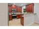 Kitchen with stainless steel appliances, granite countertops, wood cabinets, and light wood flooring at 3877 Lake Sanctuary Way, Atlanta, GA 30349