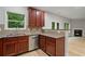Kitchen featuring granite countertops, stainless steel dishwasher, and wooden cabinets at 3877 Lake Sanctuary Way, Atlanta, GA 30349