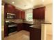 Beautiful kitchen with cherry cabinets, granite counters, and stainless steel appliances at 3877 Lake Sanctuary Way, Atlanta, GA 30349