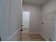 Functional laundry area includes shelving for storage, with a view to the walk-in closet at 3877 Lake Sanctuary Way, Atlanta, GA 30349