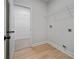 Laundry room features shelving and hookups for appliances at 3877 Lake Sanctuary Way, Atlanta, GA 30349