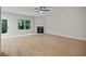 Spacious living room with fireplace, light wood flooring, and natural light at 3877 Lake Sanctuary Way, Atlanta, GA 30349