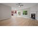 Bright living room with fireplace and light wood floors, seamlessly connects to the kitchen area at 3877 Lake Sanctuary Way, Atlanta, GA 30349