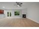 Open living area featuring a fireplace, light wood flooring, and access to the outdoors at 3877 Lake Sanctuary Way, Atlanta, GA 30349