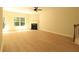 Bright, open living room featuring a fireplace, ceiling fan, and large window at 3877 Lake Sanctuary Way, Atlanta, GA 30349