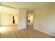 Bright, spacious living room with light wood floors and recessed lighting at 3877 Lake Sanctuary Way, Atlanta, GA 30349