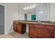 Main bathroom featuring double vanity with granite countertop and large mirror at 3877 Lake Sanctuary Way, Atlanta, GA 30349