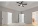 Spacious main bedroom with a tray ceiling, walk-in closet, and neutral carpet at 3877 Lake Sanctuary Way, Atlanta, GA 30349