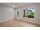 Bright room featuring light wood floors, a window for natural light, and a glass-paneled door at 3877 Lake Sanctuary Way, Atlanta, GA 30349
