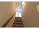 Bright stairway with wooden handrail and neutral carpet leading to the upper level at 3877 Lake Sanctuary Way, Atlanta, GA 30349