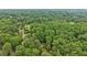 Expansive aerial view of a home surrounded by a dense forest, highlighting its secluded location at 5259 Sugar Ridge Dr, Sugar Hill, GA 30518