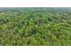 Breathtaking aerial view of a home nestled in a dense forest, showcasing a serene and secluded setting at 5259 Sugar Ridge Dr, Sugar Hill, GA 30518