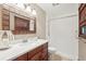 Nicely decorated bathroom featuring earth tones, patterned mirror frame, and a shower at 5259 Sugar Ridge Dr, Sugar Hill, GA 30518