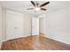 Bedroom with hardwood floors, a ceiling fan, and double door closet at 5259 Sugar Ridge Dr, Sugar Hill, GA 30518