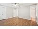 Bedroom featuring hardwood floors and doorways leading to closet and bathroom at 5259 Sugar Ridge Dr, Sugar Hill, GA 30518