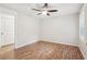 Bedroom featuring hardwood floors, a modern ceiling fan, and natural light at 5259 Sugar Ridge Dr, Sugar Hill, GA 30518