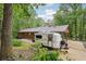Exterior view showcasing a single-story home with a covered carport and an adjacent camper parked in the driveway at 5259 Sugar Ridge Dr, Sugar Hill, GA 30518
