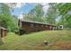 Charming single-story home with a lush green lawn and mature trees in a peaceful, wooded setting at 5259 Sugar Ridge Dr, Sugar Hill, GA 30518