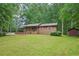 Charming single-story home featuring a covered porch, beautiful lawn, and siding at 5259 Sugar Ridge Dr, Sugar Hill, GA 30518