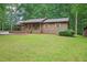 Charming single-story home featuring a covered porch, beautiful lawn, and siding at 5259 Sugar Ridge Dr, Sugar Hill, GA 30518