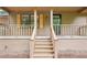 Lovely view of the exterior with charming porch, wood railings, and painted siding at 5259 Sugar Ridge Dr, Sugar Hill, GA 30518