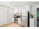 Well-lit kitchen featuring stainless steel appliances, granite countertops, and white cabinets at 5259 Sugar Ridge Dr, Sugar Hill, GA 30518