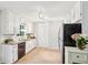 Charming kitchen features granite countertops, stainless appliances, and ample white cabinetry with an adjacent dining area at 5259 Sugar Ridge Dr, Sugar Hill, GA 30518