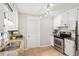 Bright kitchen featuring granite countertops, stainless appliances, and classic white cabinetry with plenty of natural light at 5259 Sugar Ridge Dr, Sugar Hill, GA 30518