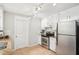 Updated kitchen featuring granite countertops, stainless appliances, white cabinets, and modern lighting for a move in ready experience at 5259 Sugar Ridge Dr, Sugar Hill, GA 30518
