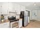Updated kitchen featuring stainless steel appliances, granite countertops, white subway tile backsplash and a tile floor at 5259 Sugar Ridge Dr, Sugar Hill, GA 30518
